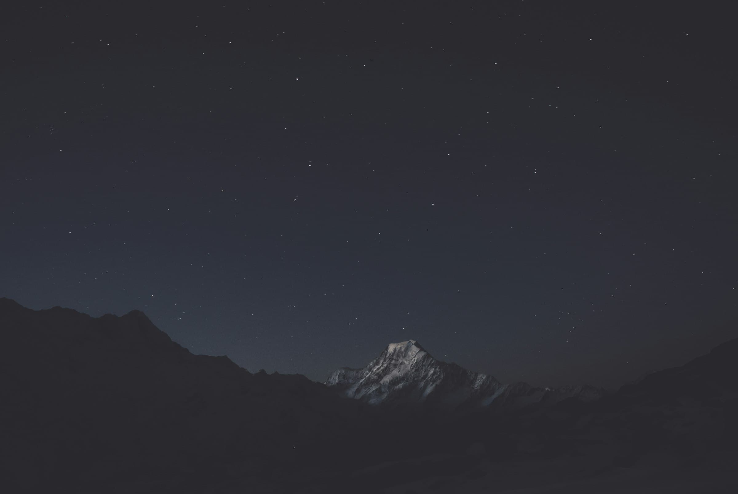 A snow-covered mountain at night